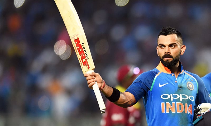 Virat Kohli holding up his Cricket Bat